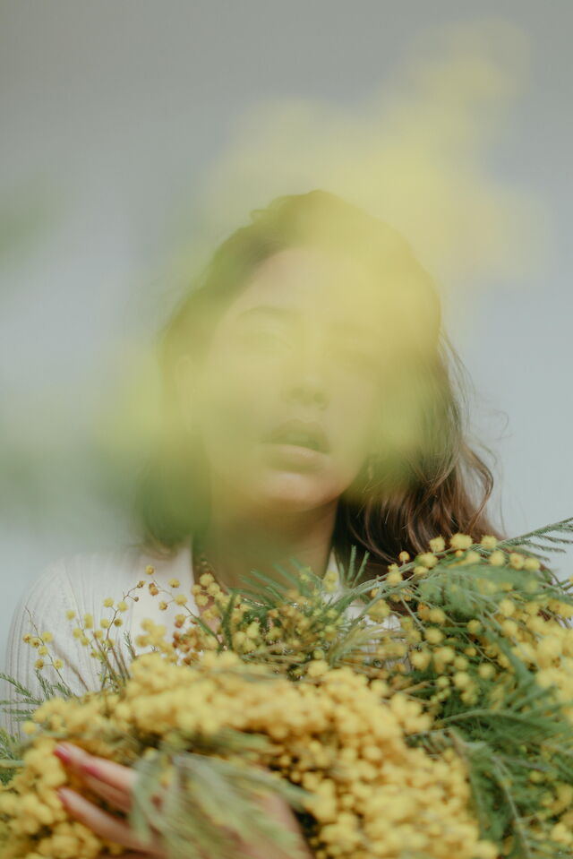 Woman with mimosa flowers