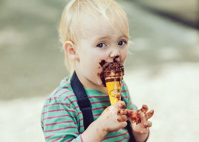 Child eating chocolate gelato