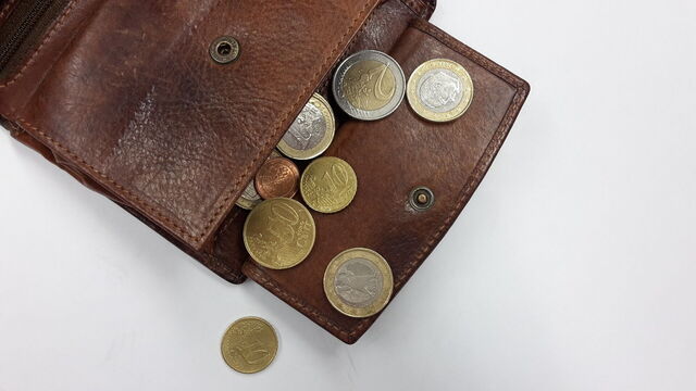 Some euros spilling out of a purse