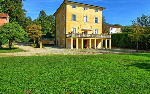 Villa Fiamma: Sky, Building, Plant, Window, Green, Cloud, Tree, Natural Landscape, Land Lot, Grass