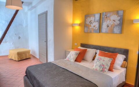 House of Stone - Deglio Faraldi: Bedroom, Room, Furniture, Bed, Property, Bed Sheet, Interior Design, Wall, Building, Orange