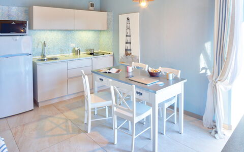 Golfo Aranci Ortensia Apartments: Room, Furniture, Property, Blue, Kitchen, Interior Design, Floor, Building, House, Table