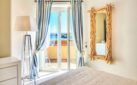 Golfo Aranci Ortensia Apartments: Property, Room, Blue, Interior Design, Floor, Yellow, Wall, Furniture, Home, House
