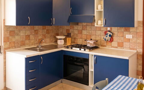 Lia: Kitchen, Kitchen Appliance, Major Appliance, Kitchen Stove, Countertop, Flooring, Wood, Cabinetry, Stove, Interior Design