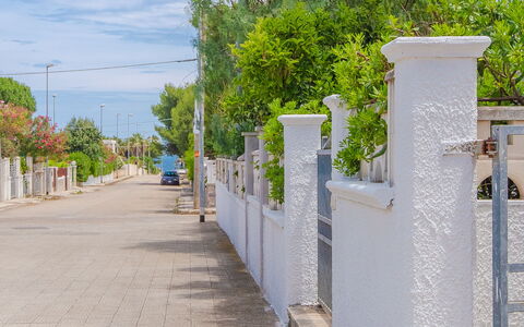 Villa Mezzaluna: Wall, Tree, Public Space, Residential Area, Neighbourhood, Sidewalk, Fence, Architecture, Walkway, Road