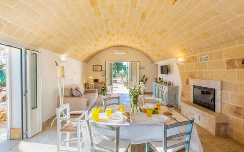 Trullo Con Piscina Per Bambini: Table, Furniture, Property, Chair, Couch, Countertop, Cabinetry, Interior Design, Kitchen, Wood