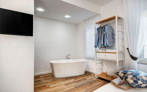 Luxury Blues Apartment: Bathtub, Building, Plumbing Fixture, Product, Window, Wood, Cabinetry, Curtain, Interior Design