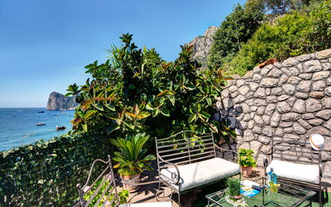 La Baia Dello Chalet: Sky, Plant, Water, Property, Plant Community, Botany, Natural Landscape, Outdoor Furniture, Vegetation, Arecales