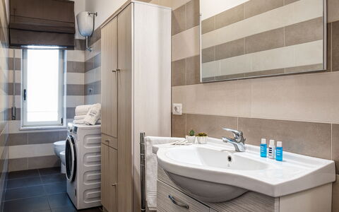 Living Times Apartment: Mirror, Tap, Plumbing Fixture, Property, Furniture, Sink, Bathroom Sink, Bathroom Cabinet, Bathroom, Building