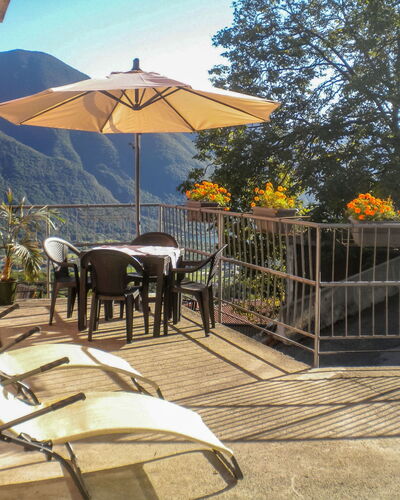 Minú: Furniture, Building, Property, Table, Umbrella, Sky, Outdoor Table, Shade, Outdoor Furniture, Chair