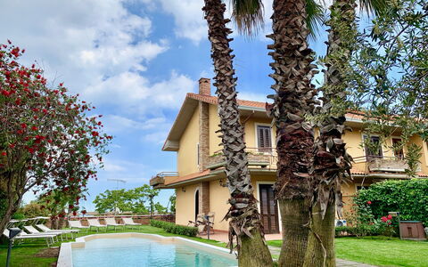 Villa Tricca: Plant, Sky, Building, Water, Cloud, Green, Tree, House, Architecture, Arecales