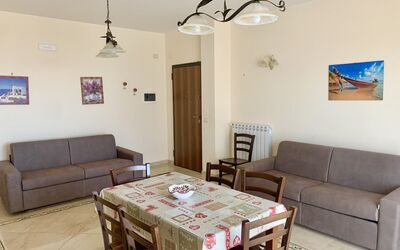 Suite Bilocale 3: Table, Furniture, Property, Couch, Picture Frame, Wood, Interior Design, Living Room, Floor, Flooring