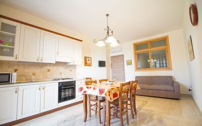 Suite Trilocale 2: Cabinetry, Table, Countertop, Furniture, Property, Wood, Kitchen, Orange, Lighting, Chair