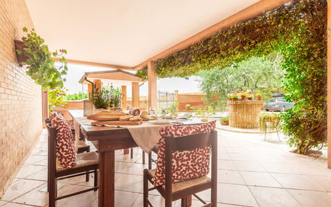 Villa Rosso Corbezzolo: Table, Plant, Property, Furniture, Chair, Flowerpot, Building, Wood, Outdoor Table, Outdoor Furniture