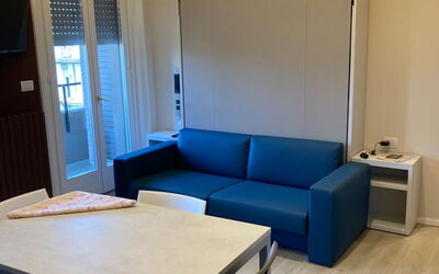 Pavia Tower 5: Table, Furniture, Property, Couch, Azure, Wood, Door, Interior Design, Flooring, Living Room