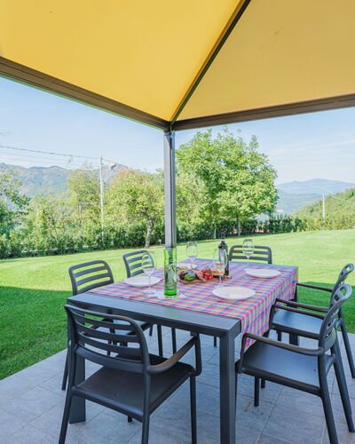 La Mela Musona: Table, Plant, Property, Furniture, Sky, Green, Outdoor Table, Chair, Shade, Tree