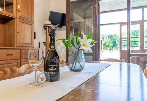 Casa Tramonti: Table, Furniture, Property, Plant, Cabinetry, Bottle, Building, Window, Wood, Countertop