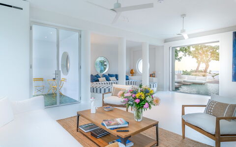 Villa Clementina: Table, Furniture, Couch, Ceiling Fan, Interior Design, Wood, Orange, Floor, Living Room, Plant