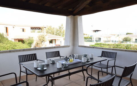 Luisa Apartment In Budoni, Shared Pool: Table, Furniture, Property, Plant, Chair, Building, Shade, Interior Design, Wood, Architecture