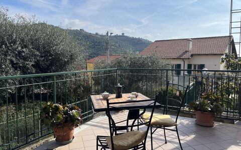 Bruna: Sky, Plant, Cloud, Building, Furniture, Flowerpot, Table, Houseplant, Chair, Outdoor Table