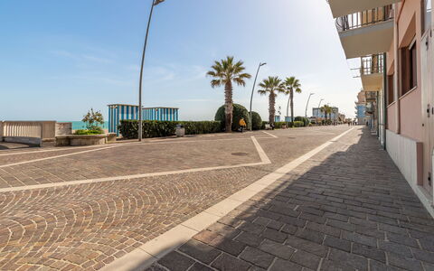 Casa Rivamare: Sky, Building, Street Light, Road Surface, Plant, Tree, Asphalt, Arecales, Flooring, Urban Design