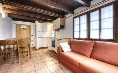 Appartamento in Centro Paese Ronco 4: Furniture, Couch, Table, Wood, Picture Frame, Living Room, Interior Design, Flooring, Floor, Chair