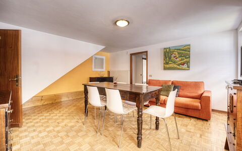 Appartamento Piazza Centrale: Table, Furniture, Building, Couch, Wood, Hall, Architecture, Interior Design, Flooring, Chair