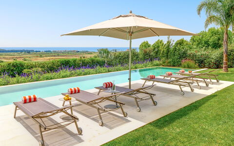 Villa Smeraldo - Sea Front | By Rocco Forte Villas: Furniture, Property, Plant, Sky, Umbrella, Table, Shade, Azure, Outdoor Furniture, Tree