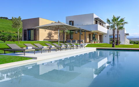 Villa Corallo - Sea Front | By Rocco Forte Villas: Water, Sky, Building, Azure, Plant, Shade, Swimming Pool, Tree, Urban Design, Residential Area