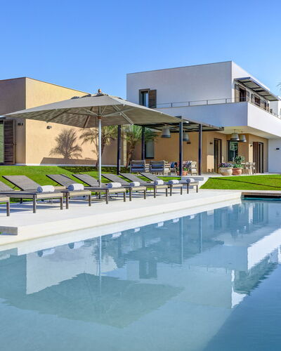 Villa Corallo - Sea Front | By Rocco Forte Villas: Water, Sky, Building, Azure, Plant, Shade, Swimming Pool, Tree, Urban Design, Residential Area