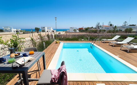 Villa Pachino: Sky, Water, Property, Plant, Furniture, Table, Building, Swimming Pool, Azure, Chair