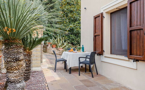 Cyca Holiday Home: Property, Table, Plant, Chair, Building, Architecture, Outdoor Furniture, Tree, Wall, Arecales