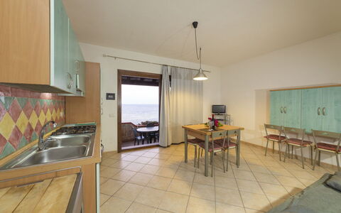 Villetta Seaside Sardegna: Furniture, Flooring, Wood, Floor, Interior Design, Table, Chair, Kitchen & Dining Room Table, Room, Sea