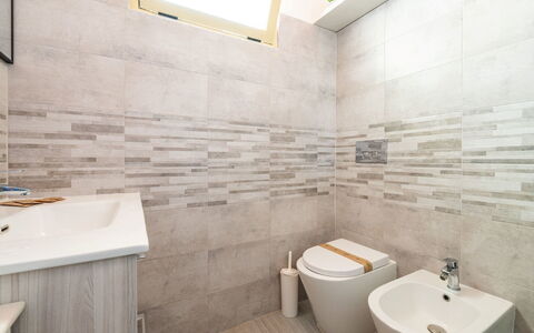 Doxina: Flooring, Floor, Plumbing Fixture, Toilet Seat, Toilet, Bathroom, Interior Design, Tile, Plumbing