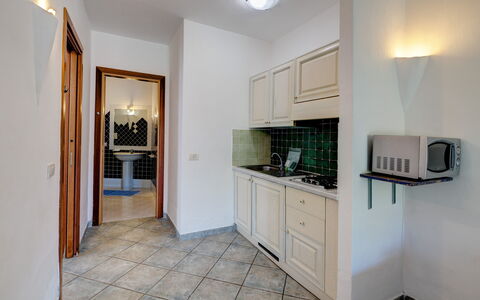 Casa Faro Green Village Sardegna: Cabinetry, Property, Furniture, Countertop, Building, Lighting, Wood, Houseplant, Drawer, Interior Design