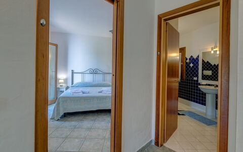 Casa Faro Green Village Sardegna: Building, Furniture, Comfort, Azure, Bed Frame, Mirror, Wood, Bed, Floor, Hardwood