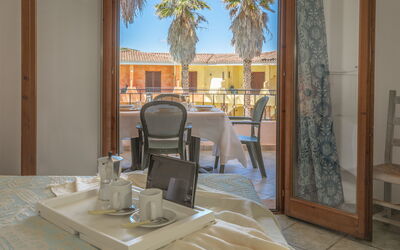 Flats Green Village Sardegna: Property, Table, Furniture, Tableware, Building, Textile, Wood, Shade, Window