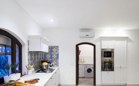 Villa Luna Blu: Interior Design, Flooring, Kitchen, Ceiling, Lighting, Countertop, Floor, Home, Light Fixture, Kitchen Appliance