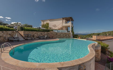 Baia Bianca Apartments Sardinia: Blue, Water, Swimming Pool, Composite Material, Resort, Outdoor Furniture, Flagstone, Water Feature, Resort Town, Villa