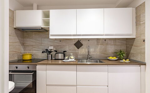 Suite Trastevere: Kitchen, Countertop, Kitchen Appliance, Cabinetry, Furniture, Interior Design, Major Appliance, Flooring, Wood, Home Appliance