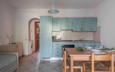 Appartamento Macchia: Flooring, Interior Design, Floor, Furniture, Room, Apartment, Countertop, Ceiling, Kitchen, Kitchen & Dining Room Table
