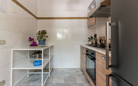 Villa Coralia: Flooring, Countertop, Interior Design, Kitchen, Cabinetry, Wood, Floor, Furniture, Kitchen Appliance, Major Appliance