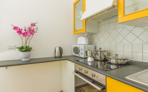 Villa San Vito: Kitchen, Countertop, Kitchen Appliance, Major Appliance, Interior Design, Yellow, Wood, Furniture, Flooring, Cabinetry