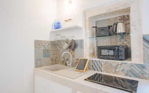 Casa Bolero: Flooring, Interior Design, Floor, Tile, Countertop, Kitchen, Mosaic, Ceramic, Light Fixture, Major Appliance