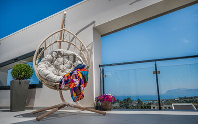 Attico Sea View: Furniture, Interior Design, Chair, Outdoor Furniture, Natural Material, Wood Flooring, Living Room, Wicker, Houseplant, Design