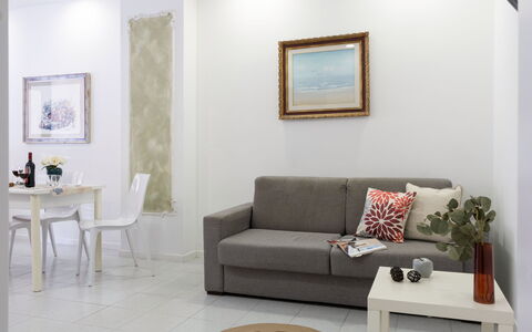 La Rondine Apartment: Furniture, Interior Design, Couch, Wall, Flooring, Floor, Living Room, Room, Table, Lighting