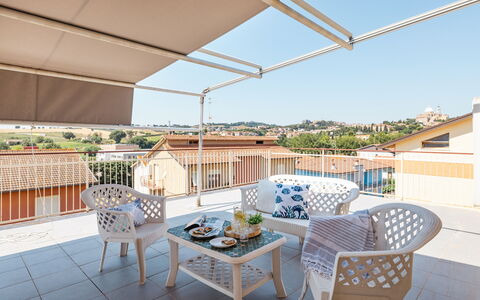 Sopraloreto Apartment: Furniture, Outdoor Furniture, Chair, Composite Material, Shade, Balcony, Awning, Apartment, Outdoor Table, Umbrella