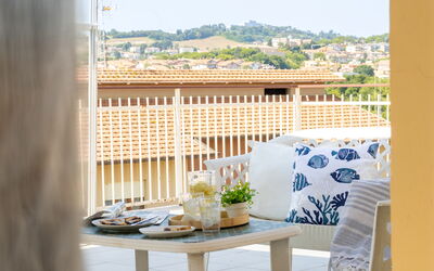 Sopraloreto Apartment: Furniture, Interior Design, Chair, Outdoor Furniture, Balcony, Shade, Wood Stain, Design, Houseplant, Linens