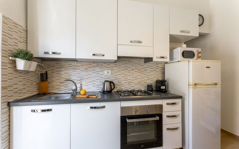 Casa La Conchiglia: Kitchen, Kitchen Appliance, Countertop, Cabinetry, Major Appliance, Furniture, Wood, Interior Design, Kitchen Stove, Home Appliance