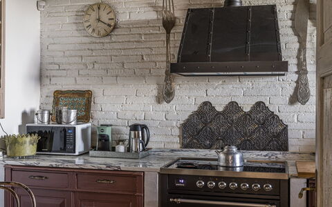 Villa Chiovada: Wall, Kitchen, Wood, Flooring, Interior Design, Kitchen Appliance, Lighting, Kitchen Stove, Light Fixture, Furniture